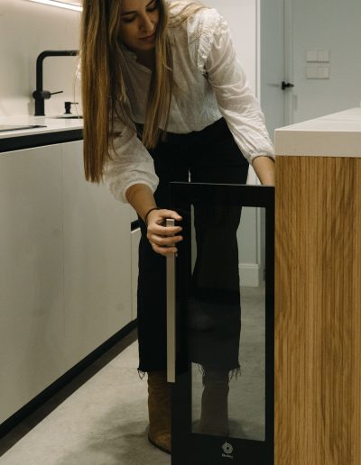 mujer abriendo vinoteca en isla con palilleria