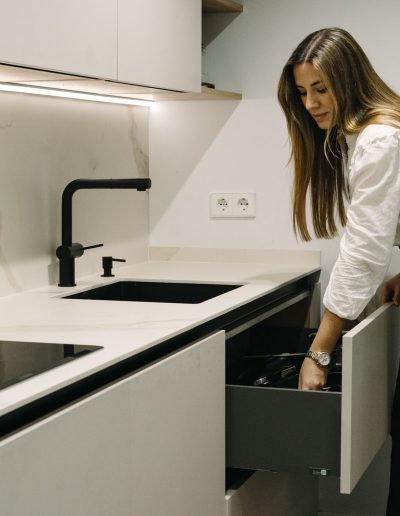 mujer abriendo gaveta en cocina